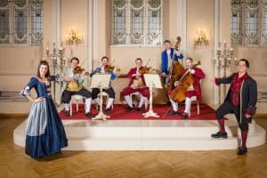 Mozart Dinner Concert ensemble in historical costumes performing in Salzburg’s Baroque Hall